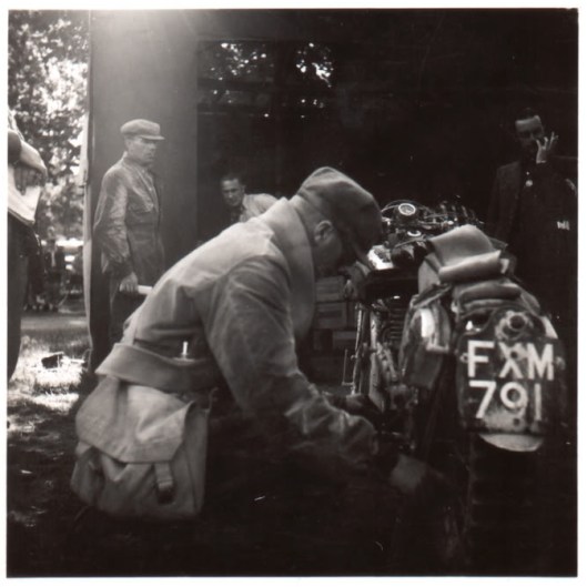 Photo of George Rowley working on his AJS at ISDT 1939