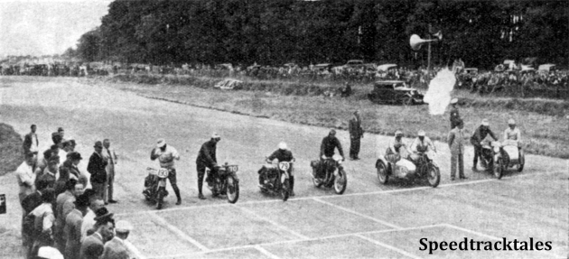 Photo - The Britian v Germany race begins. On the right is the smoke from the maroon. Note how No 193 J Stelzer (BMW) has been caught with both hands in the air, adjusting his goggles while the remainder are in the act of starting up and getting under way. The Trophy team men  (left to right are Stelzer, VN Brittain (Norton) G meier (BMW) GE Rowley (AJS) L Kraus (BMW sc) and WS Waycott (Velocette sc) ISDT 1937 (Speedtracktales Collection)