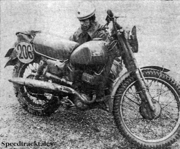 Photo - Back at the Garmisch-Partenkirchen ski-stadium used as a 'parc-ferme,' Soviet rider #206 Nicolaj Kulev gives his hefty 175cc Russian two-stroke a quick tune-up after a first day of torrential rain. ISDT 1962 (Speedtracktales Collection)