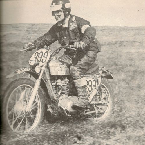 Photo of #299 Ken Heanes firing his Triumph across some open going in the ISDT 1965