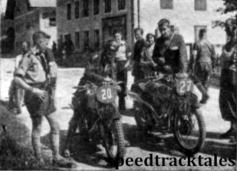 Photo - #27 Len Heath (497 Ariel) and #20 HN Toomey (498 Panther), the latter disguised by a crash helmet have a few moments to enjoy the sunshine and a cigarette while waiting their turn to enter the check. ISDT 1939 (Speedtracktales Archive)