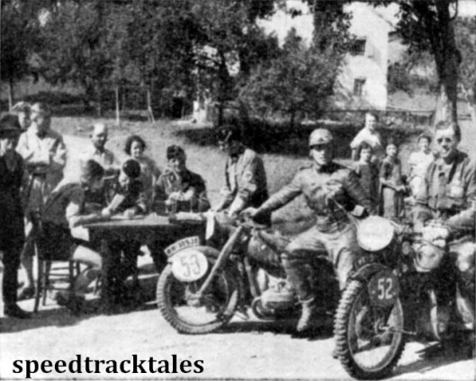 Photo - #52 Allan Jeffries (498 Triumph) wearing his usual cheery smile and #53 S Lück (494 BMW) pose for the camera while officials stamp their time cards. ISDT 1939 (Speedtracktales Archive)