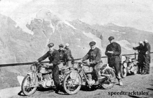 Photo - A group of British competitors pose for the camera amid the grandeur of the Grossglockner scenery. #163 is JJ Booker ( Royal Enfield) and #166 Colin Edge (347 Matchless). Behind the latter is AB Bourne the editor of 'the Motor Cycle'. ISDT 1939 (Speedtracktales Archive)