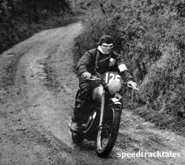 Photo - Two fingers on the clutch lever one on the front brake control, #125 Hugh Viney (347 AJS), member of the British Trophy team, looks seriously purposeful. Later he took a mild toss owing to a fallen competitor. ISDT 1950 (Speedtracktales Archive)
