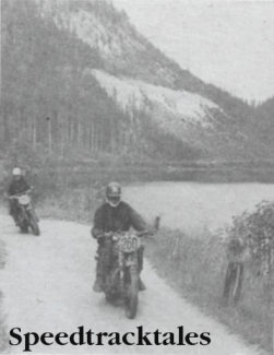 Photo - The still waters of a roadside lake frame the hasty rivals  - Peter Fletcher, British Trophy Teamster whose Royal Enfiled leads Poland's S Frantisek on his Junak ISDT 1960