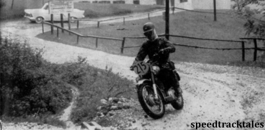 photo - British team member John Brittain (350cc Royal Enfield) undaunted by the wet conditions prevailing ISDT 1958 (Speedtracktales archive)