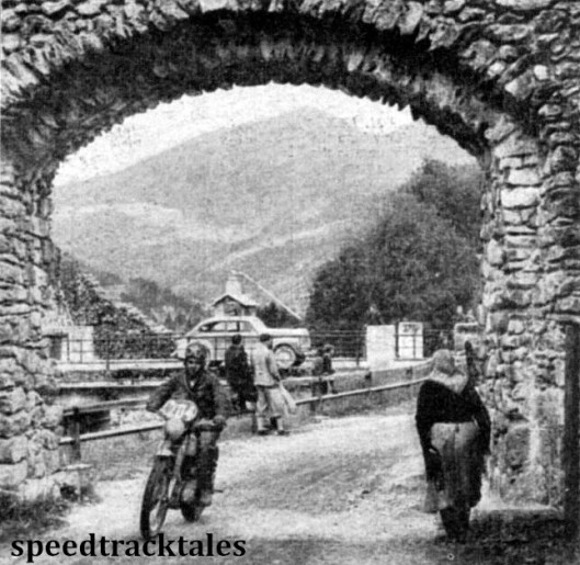 Photo - HJ Marriott (490 Norton) effectively framed on a road in Mandling while and elderly villager watches the trial go by. ISDT 1952 (Speedtracktales Collection)