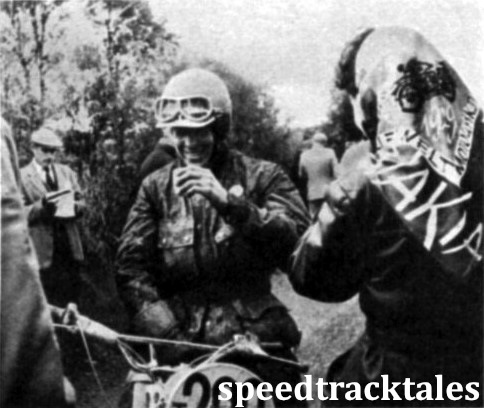 Photo - Swedish moto-cross star Rolf Tibblin enjoys a warm drink while waiting at the St. Hermon check on Tuesday. ISDT 1961