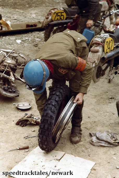 Photo - Gold medal winner #242 J Jasansky of Czechoslovakia at the end of the day fits new boots to his bike ISDT 1971 (Newark Collection)