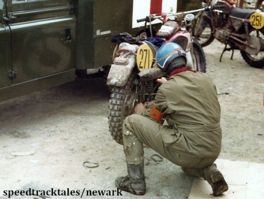 Photo - Gold medal winner #271 Z Cespiva of Czechoslovakia prepares to drop the rear wheel for a tyre change ISDT 1971 (Newark Collection)
