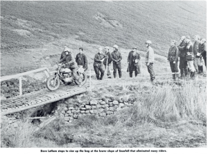 image - Dave Latham of the USA stops on a bridge to size up his way across a bog on the lower slops of Snaefell that eliminated many riders ISDT 1971